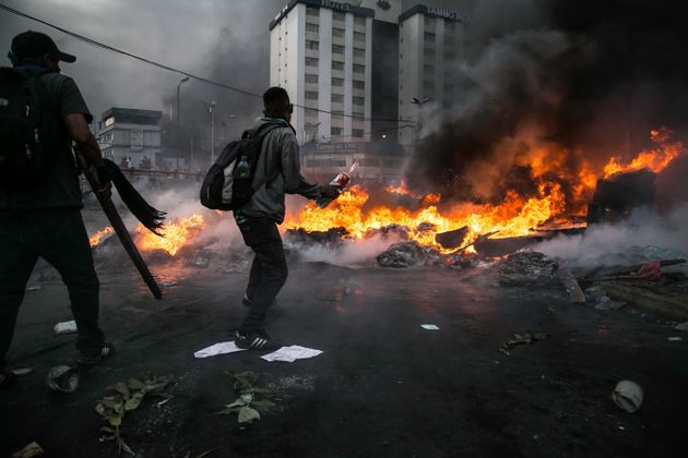 QUITO, ECUADOR - OCTOBER 12 :  A protesters gets ready to throw a molotov cocktail at the police near Casa de la Cultura as desmonstrators clash with the police during the tenth day of protests against the government, in Quito, Ecuador, 12 October 2019.   (Photo by Jonatan Rosas/Anadolu Agency via Getty Images)
