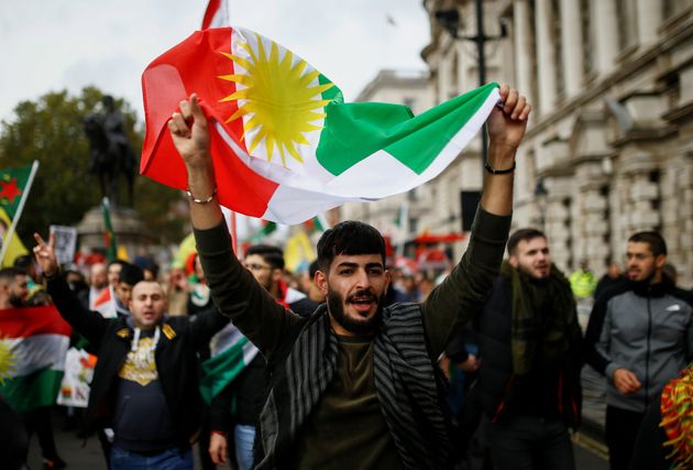 A man holds a flag during a pro-Kurdish rally against Turkey's military action in northeastern Syria, in London, Britain, October 13, 2019. REUTERS/Henry Nicholls