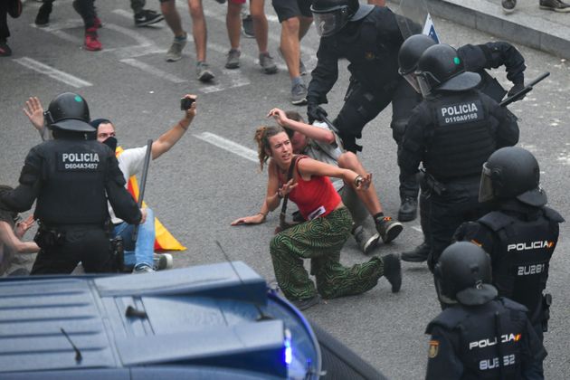 Protesters clash with Spanish policemen outside El Prat airport in Barcelona on October 14, 2019 as thousands of angry protesters took to the streets after Spain's Supreme Court sentenced nine Catalan separatist leaders to between nine and 13 years in jail for sedition over the failed 2017 independence bid. - As the news broke, demonstrators turned out en masse, blocking streets in Barcelona and elsewhere as police braced for what activists said would be a mass response of civil disobedience. (Photo by LLUIS GENE / AFP) (Photo by LLUIS GENE/AFP via Getty Images)