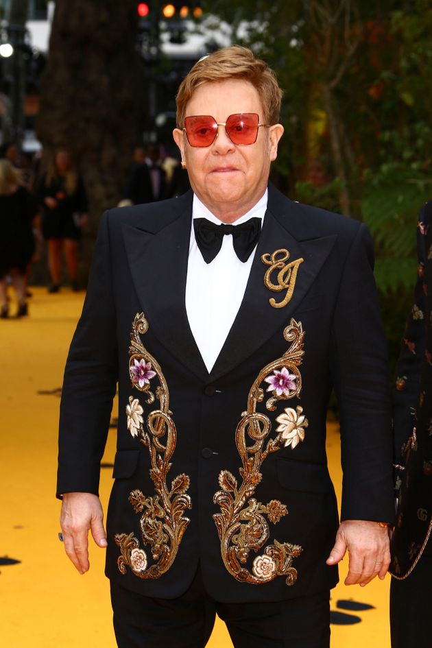 Singer Elton John poses for photographers upon arrival at the 'Lion King' European premiere in central London, Sunday, July 14, 2019. (Photo by Joel C Ryan/Invision/AP)
