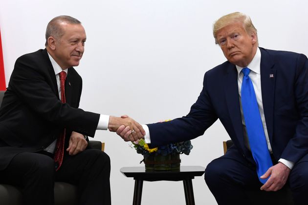 President Donald Trump, right, shakes hands with Turkish President Recep Tayyip Erdogan, left, during a meeting on the sidelines of the G-20 summit in Osaka, Japan, Saturday, June 29, 2019. (AP Photo/Susan Walsh)