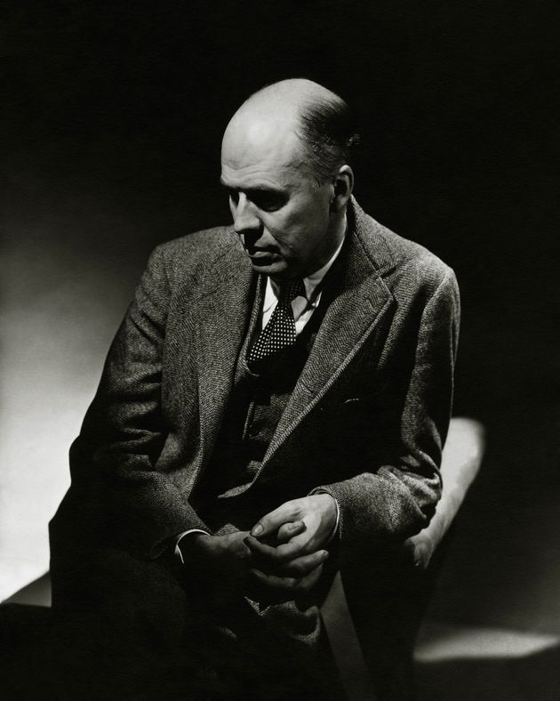 Artist, Edward Hopper, wearing a three-piece tweed suit, and polka dot tie, sitting in an arm chair in partial shadow, and looking down with a somber expression. (Photo by Lusha Nelson/Condé Nast via Getty Images)