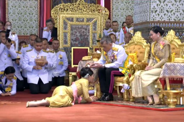 This screengrab from Thai TV Pool video taken on May 5, 2019 shows Thailand's King Maha Vajiralongkorn anointing his daughter Princess Sirivannavari Nariratana while Queen Suthida looks on during a ceremony at the Grand Palace in Bangkok. - Thai King Maha Vajiralongkorn was crowned on May 4 with a golden-tiered headpiece, the highlight of an elaborate three-day coronation ceremony two years after he ascended the throne. (Photo by Thai TV Pool / THAI TV POOL / AFP) (Photo credit should read THAI TV POOL/AFP/Getty Images)