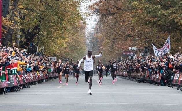 Kenya's Eliud Kipchoge (L) celebrates after busting the mythical two-hour barrier for the marathon on October 12 2019 in Vienna. - Kenya's Eliud Kipchoge on Saturday made history, busting the mythical two-hour barrier for the marathon on a specially prepared course in a huge Vienna park.
With an unofficial time of 1hr 59min 40.2sec, the Olympic champion became the first ever to run a marathon in under two hours in the Prater park with the course readied to make it as even as possible. (Photo by ALEX HALADA / AFP) (Photo by ALEX HALADA/AFP via Getty Images)