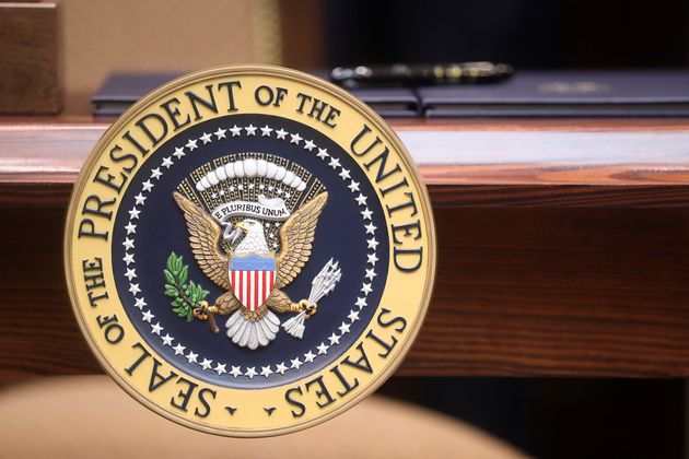 An executive order sits atop a desk adorned with the presidential seal prior to U.S. President Donald Trump signing executive orders on 'transparency in federal guidance and enforcement' in the Roosevelt Room of the White House in Washington, U.S., October 9, 2019. REUTERS/Jonathan Ernst
