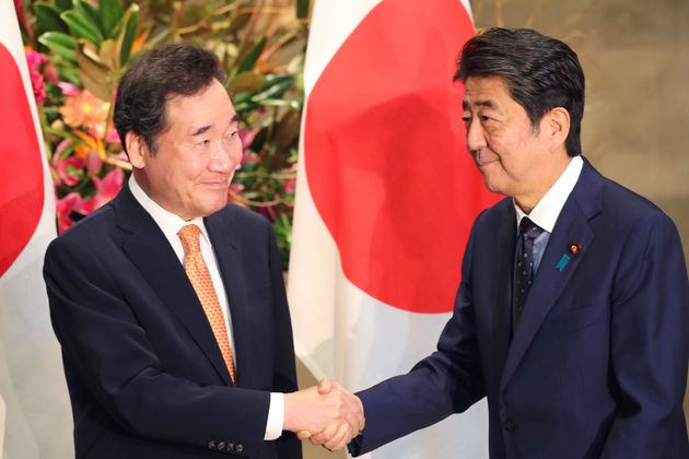 South Korea's Prime Minister Lee Nak-yon, left, shakes hands with Japanese Prime Minister Shinzo Abe prior to their meeting at Abe's official residence in Tokyo, Thursday, Oct. 24, 2019. Abe held talks with Lee in a first high-level meeting amid tension between the two neighbors over trade and wartime history. Lee, known as Japan expert, attended Emperor Naruhito’s enthronement ceremony Tuesday and was expected to propose improving ties. (AP Photo/Koji Sasahara)