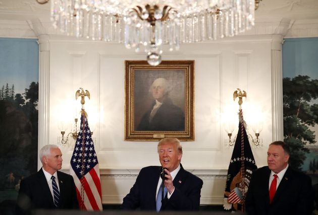 WASHINGTON, DC - OCTOBER 23: U.S. President Donald Trump is flanked by Vice President Mike Pence (L), and Secretary of State Mike Pompeo (R), while making a statement in the Diplomatic Room at the White House, on October 23, 2019 in Washington, DC. President Trump announced that the U.S. would be lifting all sanctions imposed on Turkey in response to their invasion of northern Syria. (Photo by Mark Wilson/Getty Images)