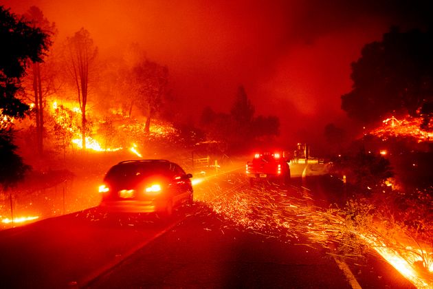 Embers fly across a roadway as the Kincade Fire burns through the Jimtown community of Sonoma County, Calif., on Thursday, Oct. 24, 2019. (AP Photo/Noah Berger)