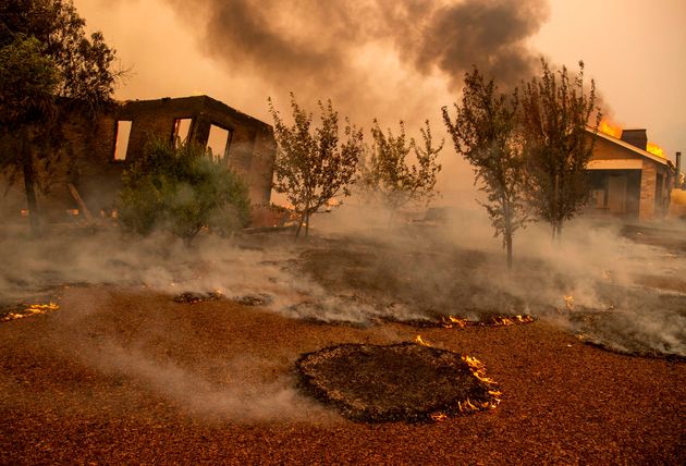 Structures burn at a vineyard during the Kincade fire near Geyserville, California on October 24, 2019. - fast-moving wildfire roared through California wine country early Thursday, as authorities warned of the imminent danger of more fires across much of the Golden State. The Kincade fire in Sonoma County kicked up Wednesday night, quickly growing from a blaze of a few hundred acres into an uncontained 10,000-acre (4,000-hectare) inferno, California fire and law enforcement officials said. (Photo by Josh Edelson / AFP) (Photo by JOSH EDELSON/AFP via Getty Images)