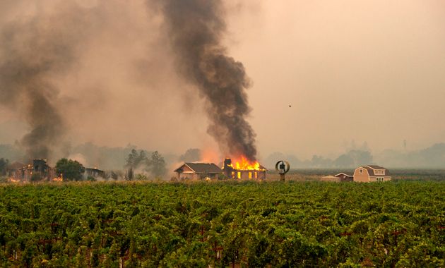 A building is engulfed in flames at a vineyard during the Kincade fire near Geyserville, California on October 24, 2019. - fast-moving wildfire roared through California wine country early Thursday, as authorities warned of the imminent danger of more fires across much of the Golden State. The Kincade fire in Sonoma County kicked up Wednesday night, quickly growing from a blaze of a few hundred acres into an uncontained 10,000-acre (4,000-hectare) inferno, California fire and law enforcement officials said. (Photo by Josh Edelson / AFP) (Photo by JOSH EDELSON/AFP via Getty Images)