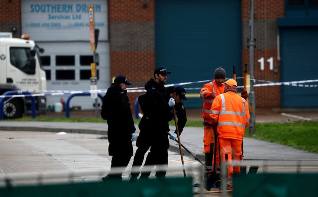 Police officers inspect a drain at the scene where bodies were discovered in a lorry container, in Grays, Essex, Britain October 24, 2019. REUTERS/Simon Dawson