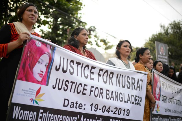 FILE - In this Friday, April 19, 2019, file photo, protesters gather to demand justice for an 18-year-old woman Nusrat Jahan Rafi who was killed after she was set on fire for refusing to drop sexual harassment charges against her Islamic school's principal, in Dhaka, Bangladesh. A court in eastern Bangladesh has sentenced the principal of the Islamic school and 15 others to death for killing Rafi, who died after being set on fire for refusing to drop sexual harassment charges against the principal. Judge Mamunur Rashid of the Women and Children Repression Prevention Tribunal on Thursday, Oct. 24, found Principal Siraj Ud Doula and others guilty of either killing her or ordering the murder in April. (AP Photo/Mahmud Hossain Opu, File)