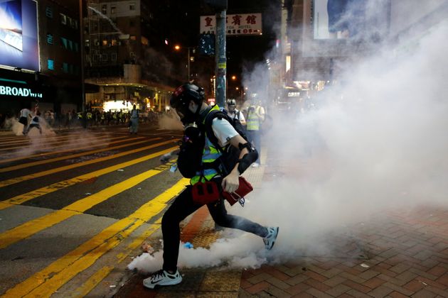 A first aid volunteer kicks a tear gas canister during an anti-government protest at Mong Kok in Hong Kong, China October 27, 2019. REUTERS/Tyrone Siu