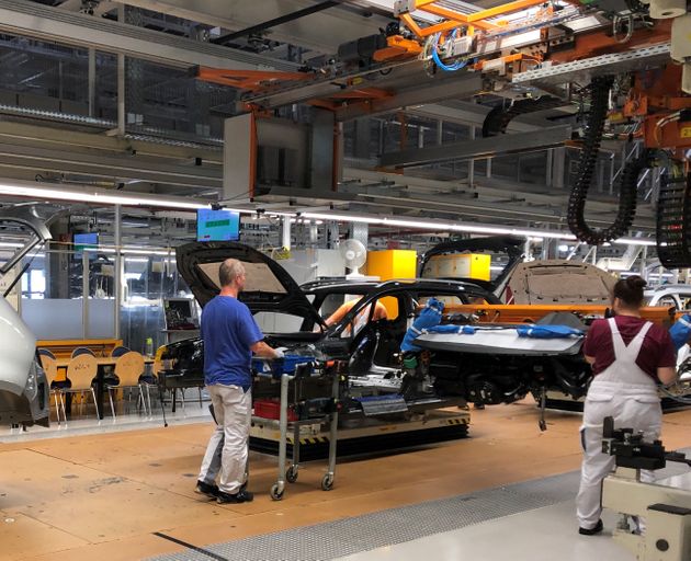 Workers install dashboards in Volkswagen ID.3 cars at the automaker's Zwickau assembly plant in Zwickau, Germany, September 13, 2019. Picture taken September 13, 2019. REUTERS/Joe White