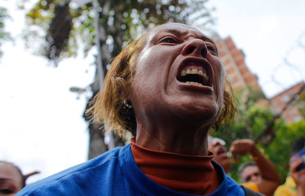 An opposition protester yells at soldiers of the National Guard blocking the way to the headquarters of the electricity State company in Caracas, Venezuela, Thursday, Oct. 24, 2019. Demonstrators mobilized in support of the inhabitants of the western state of Zulia, which suffers daily power outages that sometimes last more than 20 hours. (AP Photo/Ariana Cubillos)