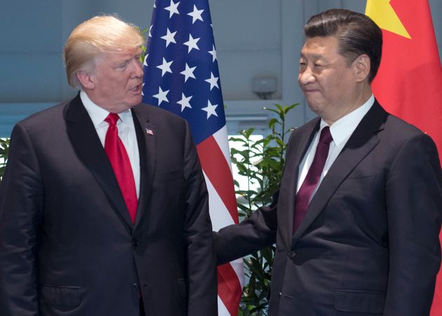 FILE - In this Saturday, July 8, 2017, file photo, U.S. President Donald Trump, left, and Chinese President Xi Jinping arrive for a meeting on the sidelines of the G-20 Summit in Hamburg, Germany. The United States apologized for mistakenly describing Xi as the leader of Taiwan, China said Monday, July 10, 2017. Chinese scholars said the mistake shows a lack of competence in the White House that is not conducive to healthy U.S.-China relations. (Saul Loeb/Pool Photo via AP, File)
