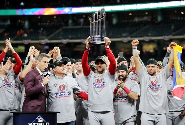 HOUSTON, TEXAS - OCTOBER 30:  Manager Dave Martinez #4 of the Washington Nationals hoists the Commissioners Trophy after defeating the Houston Astros 6-2 in Game Seven to win the 2019 World Series in Game Seven of the 2019 World Series at Minute Maid Park on October 30, 2019 in Houston, Texas. (Photo by Elsa/Getty Images)