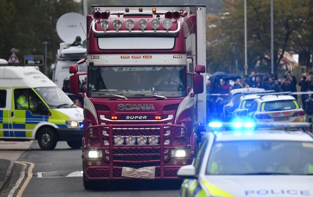 Police officers drive away a lorry (C) in which 39 dead bodies were discovered sparking a murder investigation at Waterglade Industrial Park in Grays, east of London, on October 23, 2019. - British police said 39 bodies were found near London Wednesday in the container of a truck thought to have come from Bulgaria. Essex Police said the people were all pronounced dead at the scene in an industrial park in Grays, east of London. Early indications suggest the victims are 38 adults and one teenager. A 25-year-old man from Northern Ireland has been arrested on suspicion of murder. (Photo by Ben STANSALL / AFP) (Photo by BEN STANSALL/AFP via Getty Images)