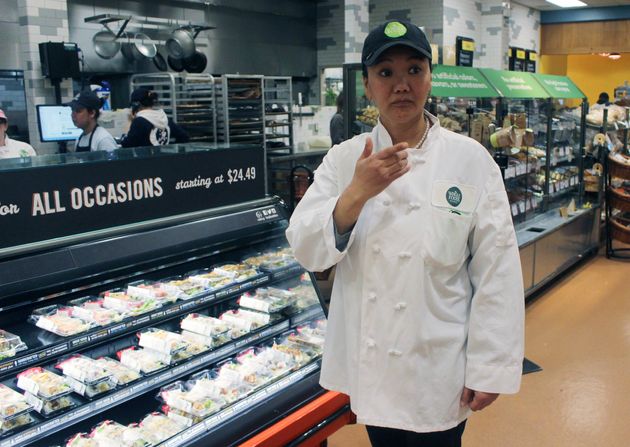 In this April 3, 2018, photo, mountain climber Lhakpa Sherpa prepares to start her shift as a dishwasher at the Whole Foods Market in West Hartford, Conn. Once a year Sherpa heads back to her native Nepal to try and break her own record for successful summits of Mount Everest by a woman. (AP Photo/Pat Eaton-Robb)