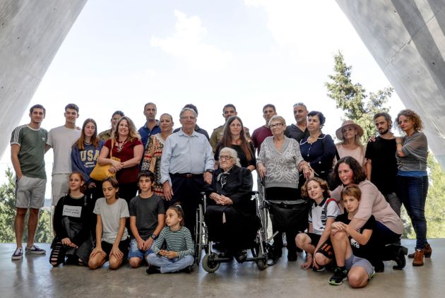Greek World War II rescuer Melpomeni Dina (C) poses for a group photo with holocaust survivors  Yossi Mor (C-L) and his sister Sarah Yanai (C-R), whom she helped escape in 1943, along with their descendants at the Hall of Names at the Yad Vashem Holocaust Memorial museum in Jerusalem on November 3, 2019. (Photo by Emmanuel DUNAND / AFP) (Photo by EMMANUEL DUNAND/AFP via Getty Images)