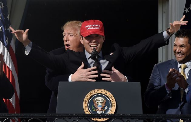 US President Donald Trump reacts as player Kurt Suzuki wears a 'Make America Great Again' baseball hat during a ceremony to welcome the 2019 World Series Champions, the Washington Nationals on the South Lawn of the White House in Washington, DC, November 04, 2019. (Photo by Olivier Douliery / AFP) (Photo by OLIVIER DOULIERY/AFP via Getty Images)