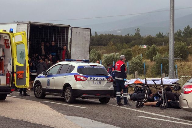 Migrants are seen inside a truck found by police, as ambulance staff arrive to the scene near the town of Xanthi, Greece, Monday, Nov. 4, 2019. Greek authorities say 41 men and boys have been found in a refrigerated truck stopped by police on a highway in northeastern Greece after it was believed to have crossed into the country from neighboring Turkey. (Stavros Karypidis/xanthinews.gr via AP)