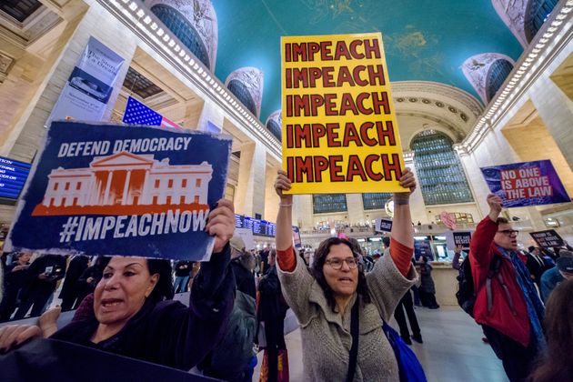 MANHATTAN, NEW YORK, UNITED STATES - 2019/11/05: Protester holding a sign reading IMPEACH. On the heels of the corrected testimony of U.S. Ambassador to the E.U. Gordon Sondland admitting he delivered a quid pro quo message to Ukraine, Members of Rise and Resist gathered at Grand Central for a protest to demonstrate public outrage at Trump and pressure on Congress to 'Impeach Now'. (Photo by Erik McGregor/LightRocket via Getty Images)