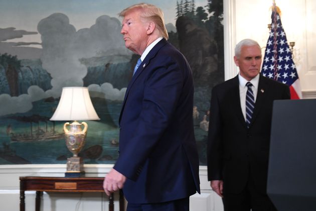 US President Donald Trump leaves after speaking about Syria in the Diplomatic Reception Room at the White House in Washington, DC, October 23, 2019 followed by US Vice President Mike Pence(R). - President Donald Trump announced on Wednesday the United States would be lifting sanctions on Turkey, hailing the success of a ceasefire along its border with Syria.'Earlier this morning, the government of Turkey informed my administration that they would be stopping combat and their offensive in Syria and making the ceasefire permanent,' he said in a televised address from the White House. (Photo by SAUL LOEB / AFP) (Photo by SAUL LOEB/AFP via Getty Images)