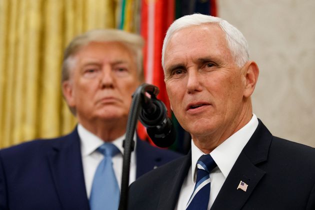 Vice President Mike Pence, right, speaks with President Donald Trump behind him, during a ceremony to present the Presidential Medal of Freedom to former Attorney General Edwin Meese, in the Oval Office of the White House, Tuesday, Oct. 8, 2019, in Washington. (AP Photo/Alex Brandon)