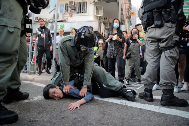 A protester is detained in Hong Kong Monday, Nov. 11, 2019. Hong Kong is in the sixth month of protests that began in June over a proposed extradition law and have expanded to include demands for greater democracy and other grievances. (AP Photo/Kin Cheung)