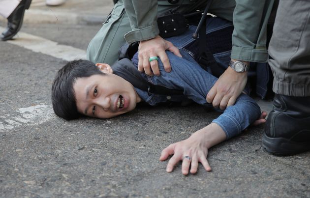 A protester is detained in Hong Kong Monday, Nov. 11, 2019. Hong Kong is in the sixth month of protests that began in June over a proposed extradition law and have expanded to include demands for greater democracy and other grievances. (AP Photo/Kin Cheung)