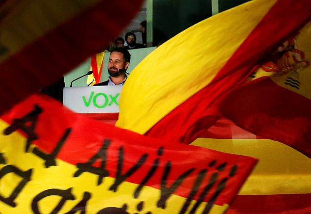 Spain's far-right party VOX candidate Santiago Abascal is seen among flags during Spain's general election at the party headquarters in Madrid, Spain, November 10, 2019. REUTERS/Susana Vera