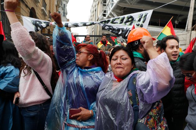 Opponents of Bolivia's President Evo Morales celebrate after he announced his resignation, in La Paz, Bolivia, Sunday, Nov. 10, 2019. (AP Photo/Juan Karita)