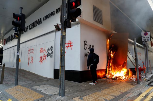 A protester writes on the wall of a Bank of China branch during a demonstration in Central, Hong Kong, China November 11, 2019. REUTERS/Thomas Peter