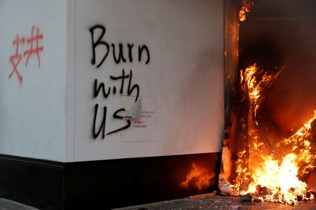 Graffiti is seen on the wall of a Bank of China branch during a demonstration in Central, Hong Kong, China November 11, 2019. REUTERS/Shannon Stapleton