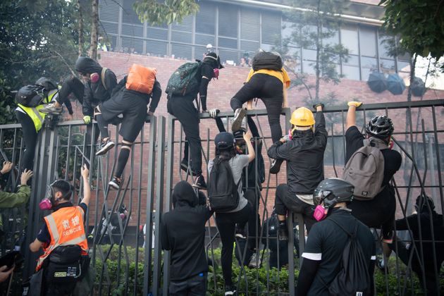 HONG KONG, CHINA - NOVEMBER 18: Anti-government protesters flee after clashing with police at Hong Kong Polytechnic University on November 18, 2019 in Hong Kong, China. Anti-government protesters organized a general strike since Monday as demonstrations in Hong Kong stretched into its sixth month with demands for an independent inquiry into police brutality, the retraction of the word 'riot' to describe the rallies, and genuine universal suffrage. (Photo by Laurel Chor/Getty Images)