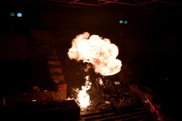 Flames rise from a large fire started by anti-government protesters in a staircase at the main entrance that leads into the Hong Kong Polytechnic University in the Hung Hom district of Hong Kong on November 18, 2019. - Hong Kong police early November 18 warned for the first time that they may use 'live rounds' after pro-democracy protesters fired arrows and threw petrol bombs at officers at a beseiged university campus, as the crisis engulfing the city veered deeper into danger. Protests have tremored through the global financial hub since June, with many in the city of 7.5 million people venting fury at eroding freedoms under Chinese rule. (Photo by Anthony WALLACE / AFP) (Photo by ANTHONY WALLACE/AFP via Getty Images)