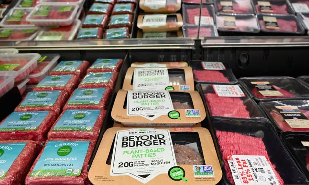 Beyond Meat 'Beyond Burger' patties made from plant-based substitutes for meat products sit alongside various packages of ground beef for sale on November 15, 2019 in New York City. - Vegetarian alternatives to burgers and sausages, revived by start-ups like Beyond Meat and Impossible Burger, are enjoying a certain enthusiasm that meat giants also want to enjoy. Since this summer, the world leader in the JBS sector has been marketing a soy burger in Brazil that includes beetroot, garlic and onions, with a look similar to a rare minced steak. In the US, the largest meat producer Tyson Foods launched a new line of products in June based on plants or mixing meat and vegetables. Its competitors Hormel Foods, Perdue Farms or Smithfield, have similar initiatives. (Photo by Angela Weiss / AFP) (Photo by ANGELA WEISS/AFP via Getty Images)