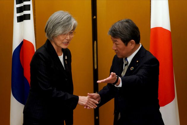 Japan's Foreign Minister Toshimitsu Motegi, right, meets with South Korea's Foreign Minister Kang Kyung-wha before a bilateral meeting during the G20 foreign ministers meeting Saturday, Nov. 23, 2019, in Nagoya, Japan. (AP Photo/Eugene Hoshiko, Pool)