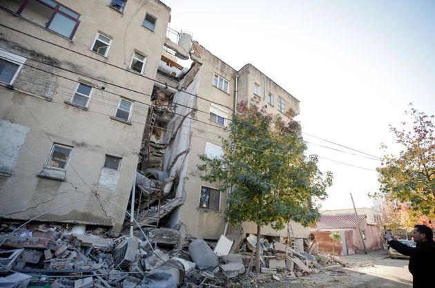 A man takes pictures of a damaged building in Durres, after an earthquake shook Albania, November 26, 2019. REUTERS/Florion Goga