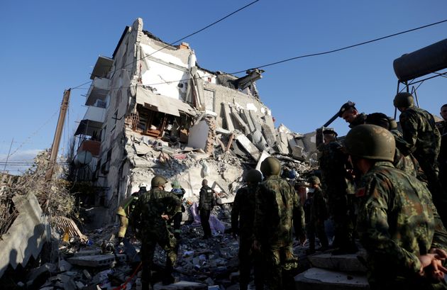 Emergency personnel work near a damaged building in Thumane, after an earthquake shook Albania, November 26, 2019. REUTERS/Florion Goga