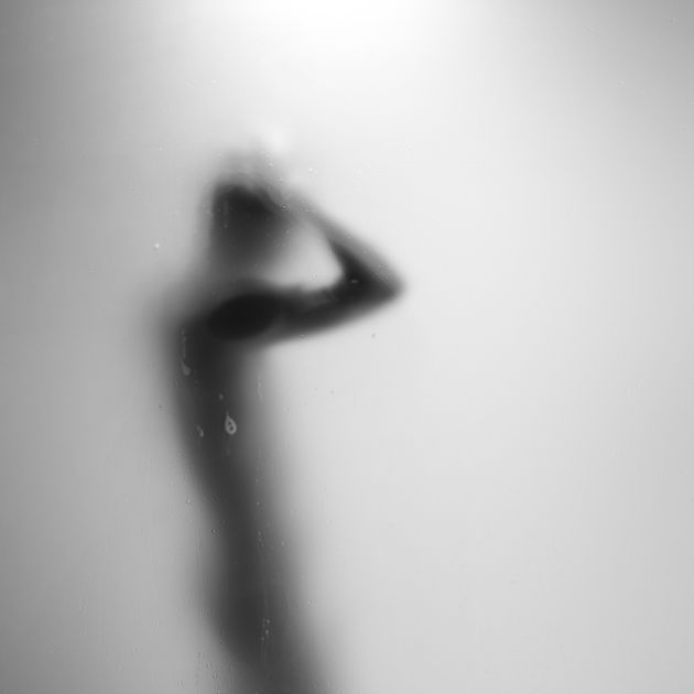 A silhouette of a man in a steamy shower.
