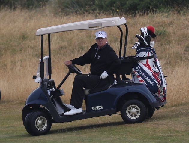 U.S. President Donald Trump drives a golf buggy on his golf course at Turnberry golf club, in Turnberry, Scotland, Sunday, July 15, 2018. President Trump and the First Lady spent the weekend in Scotland, as part of their visit to the UK before leaving for Finland where he will meet Russian leader Vladimir Putin for talks on Monday. (Andrew Milligan/PA via AP)
