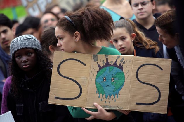 A young demonstrator holds a sign outside the Portuguese parliament in Lisbon during a worldwide protest demanding action on climate change, Friday, Nov. 29, 2019. Students worldwide are skipping class Friday to take to the streets to protest their governments' failure to take sufficient action against global warming. (AP Photo/Armando Franca)