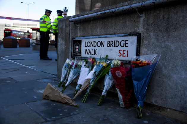 Flowers are left following Friday's terror attack on London Bridge in London, Sunday, Dec. 1, 2019.  A man wearing a fake suicide vest was subdued by bystanders as he went on a knife rampage killing two people and wounding others before being shot dead by police on Friday. (AP Photo/Alberto Pezzali)