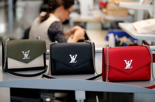 Louis Vuitton handbags are displayed as an employee works in a Vuitton new high-end garment factory in Beaulieu-sur-Layon, near Angers, France, September 5, 2019. REUTERS/Stephane Mahe