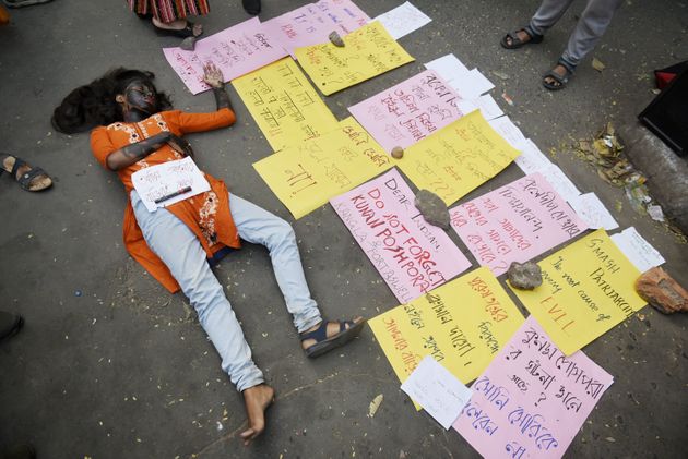 Students acts as a rape victim to protest against the alleged rape and murder of a 27-year-old veterinary doctor in Hyderabad, during a demonstration in Kolkata, India on December 2, 2019. (Photo by Indranil Aditya/NurPhoto via Getty Images)