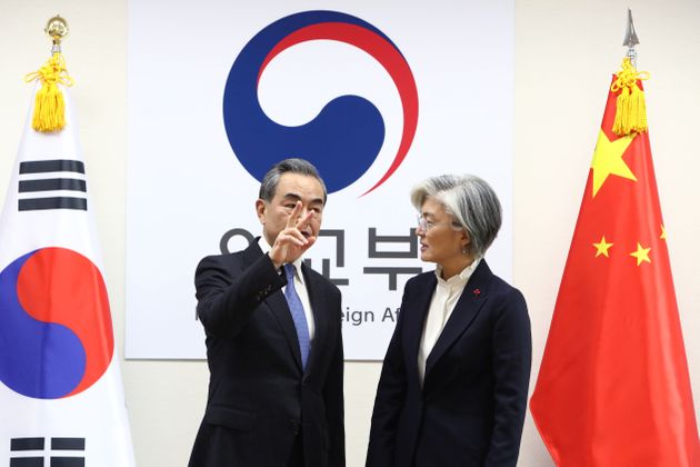 South Korea's Foreign Minister Kang Kyung-wha (R) stands with China's Foreign Minister Wang Yi (L) during their meeting at the foreign ministry in Seoul on December 4, 2019. (Photo by Chung Sung-Jun / POOL / AFP) (Photo by CHUNG SUNG-JUN/POOL/AFP via Getty Images)