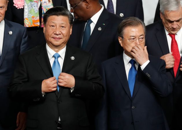 OSAKA, JAPAN - JUNE 28: Chinese President Xi Jinping and South Korean President Moon Jae-In before a family photo session at G20 summit on June 28, 2019 in Osaka, Japan. U.S. President Donald Trump arrived in Osaka on Thursday for the annual Group of 20 gathering together with other world leaders who will use the two-day summit to discuss pressing economic, climate change, as well as geopolitical issues. The US-China trade war is expected to dominate the meetings in Osaka as President Trump and China's President Xi Jinping are scheduled to meet on Saturday in an attempt to resolve the ongoing the trade clashes between the world's two largest economies. (Photo by Kim Kyung-Hoon - Pool/Getty Images)