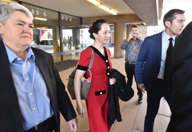 Huawei Chief Financial Officer, Meng Wanzhou, (center) leaves the British Columbia Supreme Court, in Vancouver with her security team on October 1, 2019. - The 47-year-old Huawei chief financial officer was detained during a stopover at the Vancouver airport in December 2018, on a US warrant. The US wants to put Meng on trial for fraud for allegedly violating Iran sanctions and lying about it to US banks -- accusations her lawyers dispute. Meng -- a rising star whose father Ren Zhengfei founded Huawei and over three decades grew it into a global telecom giant -- expressed surprise when told she was being arrested, according to a transcript of her speaking with authorities after her flight from Hong Kong landed. (Photo by Don MacKinnon / AFP) (Photo by DON MACKINNON/AFP via Getty Images)